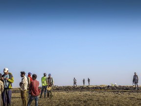 Rescuers search at the scene of an Ethiopian Airlines flight that crashed shortly after takeoff at Hejere near Bishoftu, or Debre Zeit, some 50 kilometers (31 miles) south of Addis Ababa, in Ethiopia Sunday, March 10, 2019. The Ethiopian Airlines flight crashed shortly after takeoff from Ethiopia's capital on Sunday morning, killing all 157 on board, authorities said, including 18 Canadians. THE CANADIAN PRESS/AP