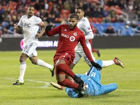 New England Revolution goalkeeper Brad Knighton (18) saves at the feet of Toronto FC forward Jordan Hamilton (7) during first half MLS soccer action in Toronto on March 17, 2019. A win over visiting New York City FC on Friday and Toronto FC can accomplish something it failed to do all of last season -- win three league games in a row. Toronto will be boosted in the attempt by the expected debut of Spanish attacker Alejandro Pozuelo.