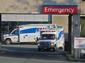 Paramedics are seen at the Dartmouth General Hospital in Dartmouth, N.S. on July 4, 2013. The union for Nova Scotia's paramedics says its members are being overworked to the point that it's a public safety issue for the province. Union business agent Mike Nickerson told the legislature's health committee today that paramedics are logging overtime hours ranging from one to six hours per shift, something he says "is just not safe."