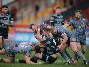 Toronto Wolfpack's Adam Sidlow (centre) is tackled in a Betfred Championship rugby league game against the Batley Bulldogs on Sunday, March 17, 2019 in Hull, England.