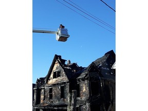 A firefighter surveys the damage following a house fire in Windsor, N.S., in this handout photo.