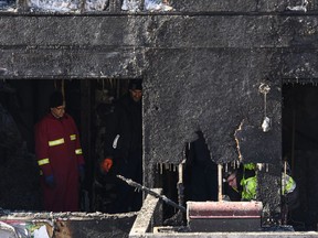 Police and firefighters investigate at the scene of a fatal house fire in the Spryfield community in Halifax on Tuesday, February 19, 2019. A group of volunteers came together to offer a session on fire prevention in the wake of a deadly house fire that claimed the lives of seven children.