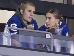 Justin Bieber watches alongside his wife Hailey Baldwin, right, during NHL hockey action between the Philadelphia Flyers and the Toronto Maple Leafs, in Toronto on Saturday, Nov. 24, 2018. Justin Bieber is asking his fans for emotional support as he works to face his personal struggles "head on."