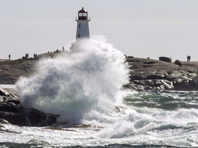 Waves hit the shore at Peggy's Cove, N.S. on Tuesday, Oct. 16, 2018 as high winds buffet the coast. Nova Scotia is proposing legislation that would set rules for coastal construction and protect features such as salt marshes and dunes as sea levels rise in the future.