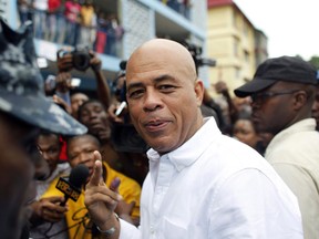 Haiti's former President Michel Martelly looks at the camera after voting in the Petion-Ville suburb of Port-au-Prince, Haiti, Sunday, Nov. 20, 2016. A group of Haitian Montrealers is appealing to federal and municipal authorities to block an upcoming concert by former Haitian president Martelly, citing what they say are his misogynistic comments aimed at women and his alleged complicity in corruption scandals