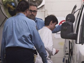 Alexandre Bissonnette is escorted to a van after appearing in court for the deadly shooting at a mosque, Monday, January 30, 2017 in Quebec City. Crown prosecutors and defence lawyers have less than a week left to decide whether to appeal the sentence handed down to the gunman who killed six men in a Quebec City mosque.