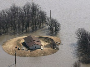 A house just north of Morris, Man. is isolated by floodwater on Tuesday, April 14, 2009. Heavy snowfall in the United States has raised the threat of flooding in Manitoba's Red River Valley this spring.