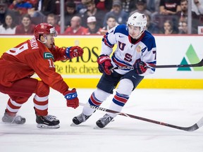 United States' Quinn Hughes, right, passes the puck past Russia's Nikita Shashkov during first period semifinal IIHF world junior hockey championship action in Vancouver, on Friday January 4, 2019. The Vancouver Canucks newest defenceman, Quinn Hughes, knows there are some high expectations as he enters his pro-hockey career. But right now, the 19-year-old just wants to get back on the ice.