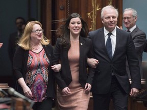 Newly-elected member of the legislature for Marie-Victorin, Catherine Fournier, centre, is escorted to her seat by Parti Quebecois Leader Jean-Francois Lisee, right, and party whip Carole Poirier, as the legislature resumes for its spring session, Tuesday, February 7, 2017 at the legislature in Quebec City. Fournier, a 26-year-old lauded as the future of the PQ, quit Monday to sit as an independent.