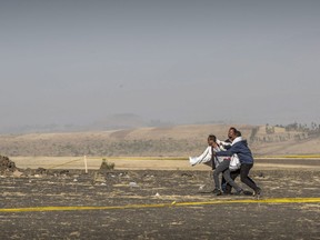 A grieving relative is held back by others at the scene where the Ethiopian Airlines Boeing 737 Max 8 crashed shortly after takeoff on Sunday killing all 157 on board, near Bishoftu, or Debre Zeit, south of Addis Ababa, in Ethiopia Wednesday, March 13, 2019. Much of the world, including the entire European Union, has grounded the Boeing jetliner involved in the Ethiopian Airlines crash or banned it from their airspace, leaving the United States as one of the few remaining operators of the plane involved in two deadly accidents in just five months.