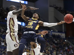 Murray State's Ja Morant (12) passes the ball under defensive pressure from Florida State's Christ Koumadje (21) during the first half of a second round men's college basketball game in the NCAA Tournament, Saturday, March 23, 2019, in Hartford, Conn.