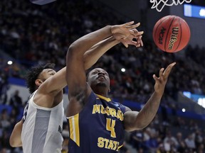 Marquette's Ed Morrow, left, blocks a shot by Murray State's Brion Sanchious (4) during the first half of a first round men's college basketball game in the NCAA Tournament, Thursday, March 21, 2019, in Hartford, Conn.