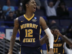 Murray State's Ja Morant (12) celebrates with Shaq Buchanan (11) during the second half of a first round men's college basketball game against Marquette in the NCAA Tournament, Thursday, March 21, 2019, in Hartford, Conn.
