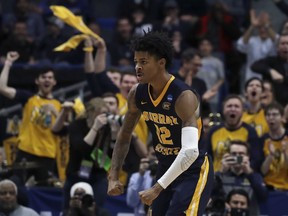 Fans cheer as Murray State's Ja Morant (12) celebrates a basket during the second half of a first round men's college basketball game against Marquette in the NCAA Tournament, Thursday, March 21, 2019, in Hartford, Conn.