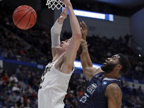 Purdue's Matt Haarms, left, is fouled as he goes to the hoop by Old Dominion's Elbert Robinson III (25) during the first half of a first round men's college basketball game in the NCAA Tournament, Thursday, March 21, 2019, in Hartford, Conn.
