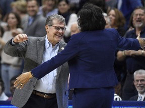Connecticut head coach Geno Auriemma, left, and Buffalo head coach Felisha Legette-Jack embrace at the start of a second-round women's college basketball game in the NCAA tournament, Sunday, March 24, 2019, in Storrs, Conn.
