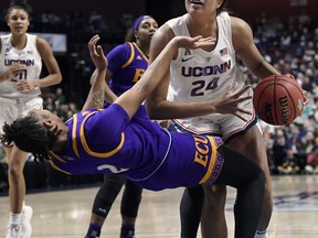 Connecticut's Napheesa Collier fouls East Carolina's Lashonda Monk, left, during the first half of an NCAA college basketball game in the American Athletic Conference tournament quarterfinals, Saturday, March 9, 2019, at Mohegan Sun Arena in Uncasville, Conn.