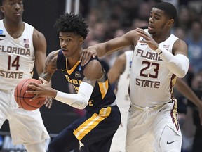 Florida State's M.J. Walker, right, fouls Murray State's Ja Morant, left, during the first half of a second round men's college basketball game in the NCAA tournament, Saturday, March 23, 2019, in Hartford, Conn.