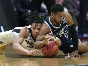 Purdue's Carsen Edwards, left, and Villanova's Phil Booth dive for a loose ball during the first half of a second round men's college basketball game in the NCAA tournament, Saturday, March 23, 2019, in Hartford, Conn.