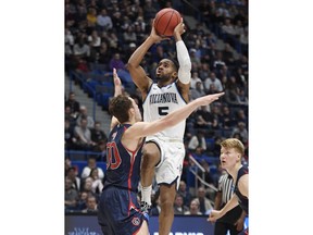 Villanova's Phil Booth (5) shoots over St. Mary's Tanner Krebs (0) during the first half of a first round men's college basketball game in the NCAA tournament, Thursday, March 21, 2019, in Hartford, Conn.