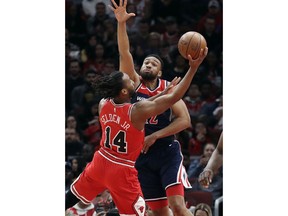 Washington Wizards forward Jabari Parker, right, guards Chicago Bulls' Wayne Selden Jr. during the first half of an NBA basketball game Wednesday, March 20, 2019, in Chicago.