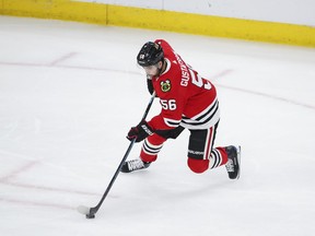 Chicago Blackhawks defenseman Erik Gustafsson (56) shoots and scores against the Philadelphia Flyers during the first period of an NHL hockey game Thursday, March 21, 2019, in Chicago.