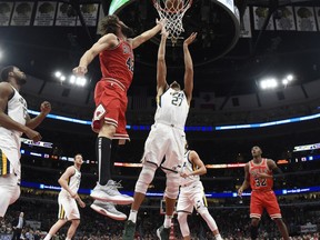 Chicago Bulls center Robin Lopez (42) shoots the ball as Utah Jazz center Rudy Gobert (27) defends him during the first half of an NBA basketball game Saturday, March 23, 2019, in Chicago.