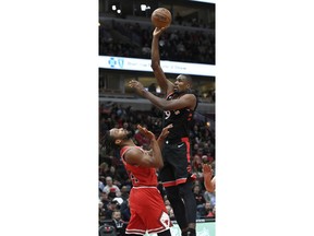 Toronto Raptors' Serge Ibaka, right, of Spain, goes up for a shot against Chicago Bulls' Wayne Selden Jr., left, during the first half of an NBA basketball game, Saturday, March 30, 2019, in Chicago.