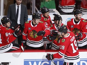 Chicago Blackhawks center Jonathan Toews (19) celebrates with teammates after his penalty goal against the Arizona Coyotes during the second period of an NHL hockey game Monday, March 11, 2019, in Chicago.