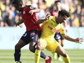 Thiago Mendes of Lille challenges for the ball with Lucas Evangelista of Nantes during a French League One soccer match between Nantes and Lille at La Beaujoire Stadium in Nantes, western France, Sunday, March 31, 2019.