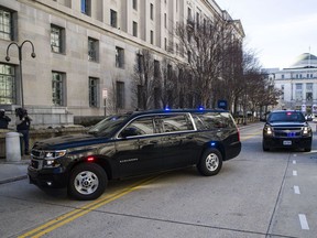 The motorcade for Attorney General William Barr arrives at the Department of Justice, Sunday, March 24, 2019, in Washington. Barr was expected to release his first summary of Mueller's findings on Sunday, people familiar with the process said, on what lawmakers anticipated could be a day of reckoning in the two-year probe into President Donald Trump and Russian efforts to elect him. Since receiving the report Friday, Barr has been deciding how much of it Congress and the public will see.