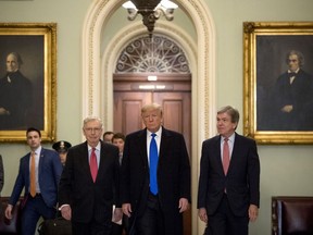 President Donald Trump accompanied by Senate Majority Leader Mitch McConnell of Ky., left, and Sen. Roy Blunt, R-Mo., right, arrives for a Senate Republican policy lunch on Capitol Hill in Washington, Tuesday, March 26, 2019.