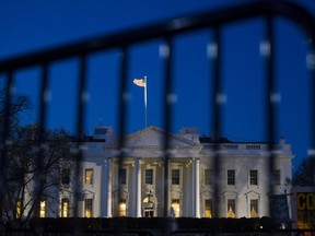 The White House is seen through a security fence, before sunrise, in Washington, Saturday, March 23, 2019. Special counsel Robert Mueller closed his long and contentious Russia investigation with no new charges, ending the probe that has cast a dark shadow over Donald Trump's presidency.