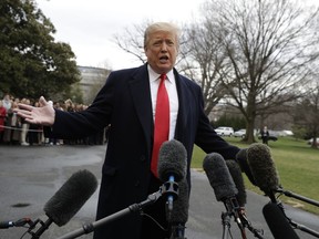 President Donald Trump talks with reporters before boarding Marine One on the South Lawn of the White House, Friday, March 22, 2019, in Washington.