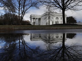 The White House is reflected in a puddle, Friday March 22, 2019, in Washington, as news breaks that the special counsel Robert Mueller has concluded his investigation into Russian election interference and possible coordination with associates of President Donald Trump. The Justice Department says Mueller delivered his final report Friday to Attorney General William Barr, who is reviewing it. Mueller's report, still confidential, sets the stage for big public fights to come. The next steps are up to Trump's attorney general, to Congress and, in all likelihood, federal courts.