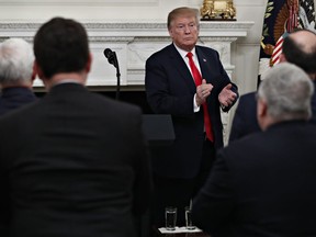 President Donald Trump applauds the attorneys general as they stand up as he finishes speaking to the National Association of Attorneys General, Monday, March 4, 2019, in the State Dining Room of the White House in Washington.
