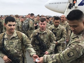Soldiers from the 1st Armored Division, based in Fort Bliss, Texas, arrives at the airport Tegel in Berlin, Thursday, March 21, 2019. Over three hundred soldiers have arrived in Germany from their base in Texas in the first test of a new American strategy to rapidly deploy troops based in the United States to Europe to bolster the NATO deterrent against possible Russian aggression.
