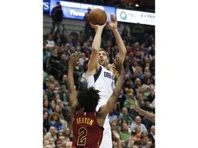 Dallas Mavericks forward Dirk Nowitzki (41) shoots over Cleveland Cavaliers guard Collin Sexton (2) during the first half of an NBA basketball game in Dallas, Saturday, March 16, 2019.