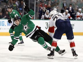 Dallas Stars defenseman Ben Lovejoy (21) is knocked off his skates by Florida Panthers center Frank Vatrano (72) as they collide in the second period of an NHL hockey game in Dallas, Tuesday, March 19, 2019.
