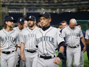 Seattle Mariners right fielder Ichiro Suzuki leaves after his team's group photo prior to Game 1 of a Major League opening series baseball game against the Oakland Athletics at Tokyo Dome in Tokyo, Wednesday, March 20, 2019.