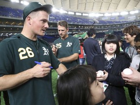 Oakland Athletics third baseman Matt Chapman (26) gives his autographs to fans prior to Game 1 of a Major League opening series baseball game between the Seattle Mariners and the Athletics at Tokyo Dome in Tokyo, Wednesday, March 20, 2019 in Tokyo,
