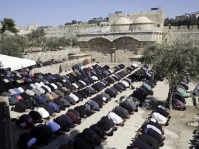 Palestinians pray at al-Aqsa mosque compound Friday, March 8, 2019. Prayers passed peacefully at Jerusalem's most sensitive holy site Friday, as Jordan confirmed it was negotiating with Israel to ease mounting tensions after Israel ordered the closure of a building at the sacred compound.