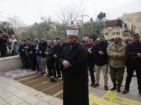Palestinians pray outside the Old City as Israeli border police blocked the entrances to Al-Aqsa compound in Jerusalem Tuesday, March 12, 2019. Israeli police on Tuesday closed the entrances to Jerusalem's most sensitive holy site after Palestinian suspects threw a firebomb at a police station.