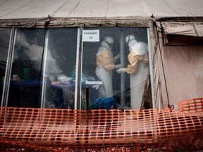 Health workers are seen inside the 'red zone' of an Ebola treatment centre, which was attacked in the early hours of the morning on March 9, 2019 in Butembo. - Armed men on March 9 attacked an Ebola treatment centre in the east of the Democratic Republic of Congo, killing a policeman and wounding a health worker, the authorities said.