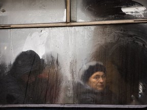 Commuters are seen through the window of a public bus as they travel in central Vinnytsia, Ukraine, Wednesday, March 27, 2019. Presidential elections will be held in Ukraine on March 31.