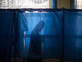 Baryshevsky Victor, Bishop of the Kiev Pechersk Lavra, holds his ballot at a polling station, during the presidential elections in Kiev, Ukraine, Sunday, March. 31, 2019.