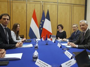 France's Finance Minister Bruno Lemaire, right, and Dutch Finance Minister Wopke Hoekstra, left, pose before a meeting, in Paris, Friday, March. 1, 2019. French President Emmanuel Macron said the Dutch government must clarify why it bought more than 12 percent of shares in the holding company for the Air France-KLM airline alliance.
