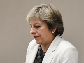 In this Friday, Oct. 20, 2017 file photo, British Prime Minister Theresa May waits for the arrival of European Council President Donald Tusk prior to a bilateral meeting with him.