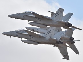 Royal Australian Air Force F-18 Hornets perform during the Australian International Airshow at the Avalon Airfield southwest of Melbourne in a file photo from Feb. 24, 2015. Canada is buying 18 of Australia's used F-18 jets.