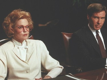 A still from Working Girl, featuring the shoulder pads and eyewear of the '80s.